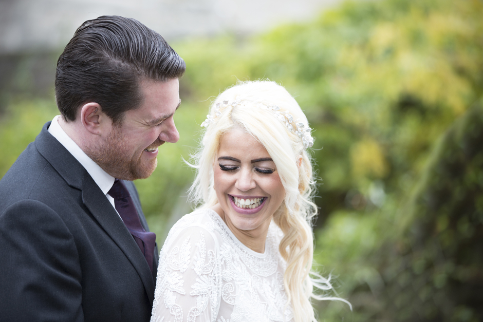 Bride laughing with groom at Archbishop's Palace in Maidstone, Kent.