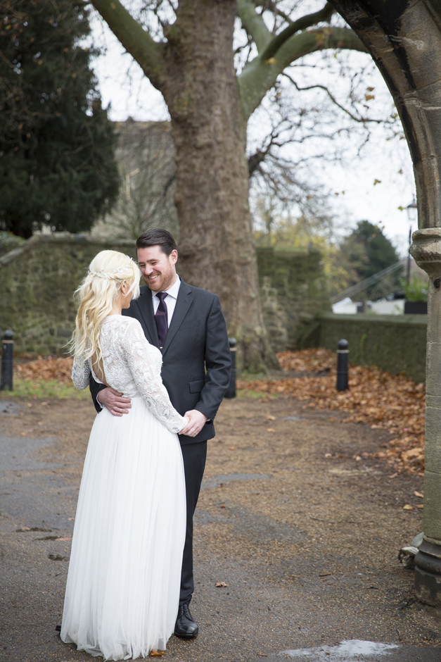Bride and Groom standing in an embrace outside Maidstone Canal in kent.
