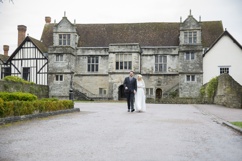 Bride and Groom walking outside Archbishop's Palace in Maidstone, Kent.