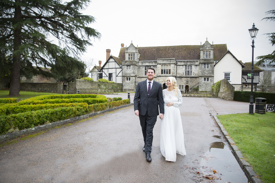 Groom and Bride walking away from Archbishop's Palace in Maidstone, Kent.