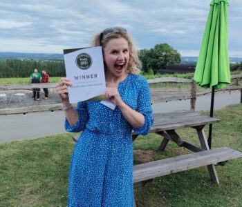 Victoria Green Wedding Photographer holding winners certificate for Muddy Stilettos Best Wedding Photographer 2023